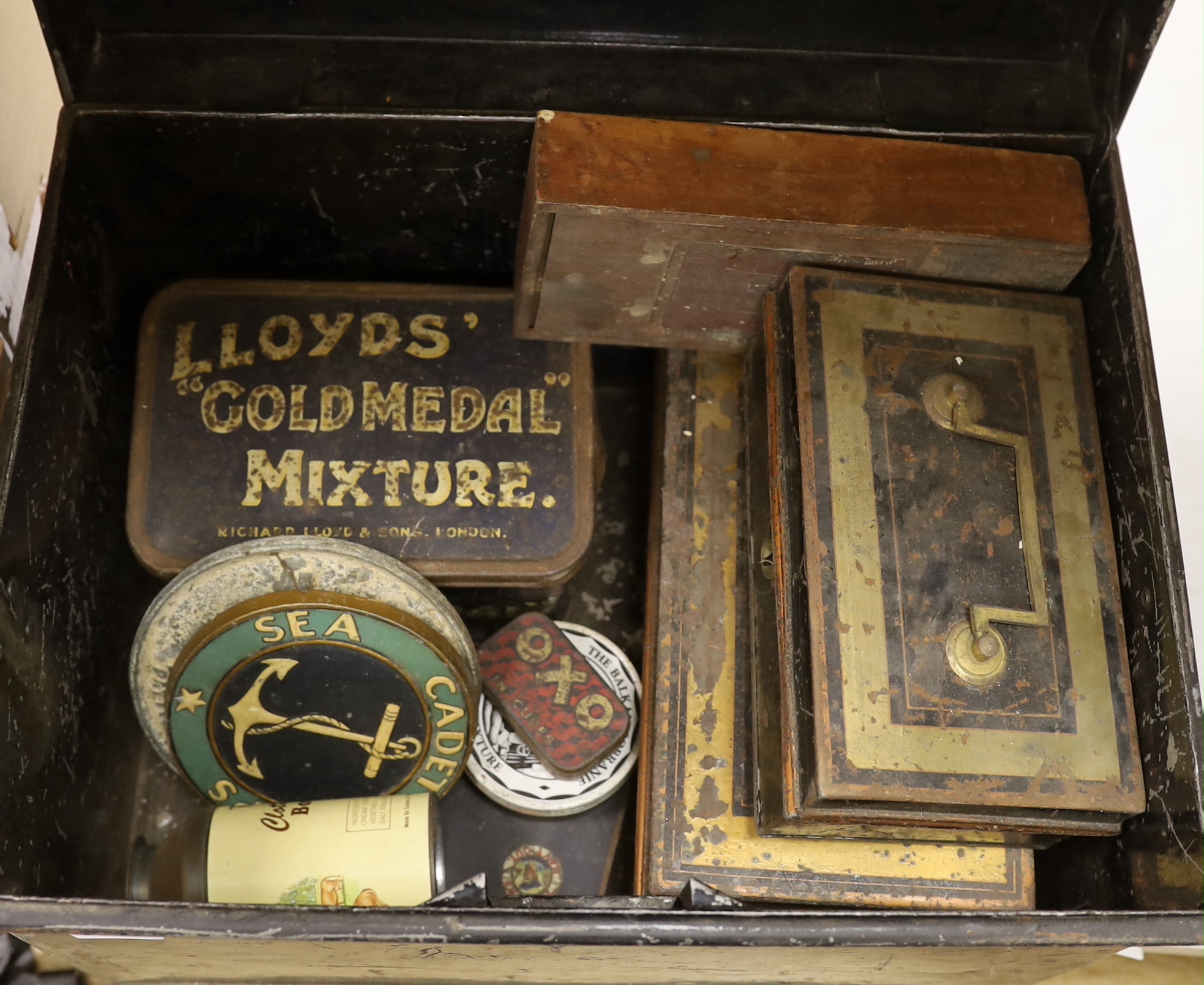 A collection of early to mid century and 20th century tins, a ladies tea disc, a sea cadet corps disc/badge